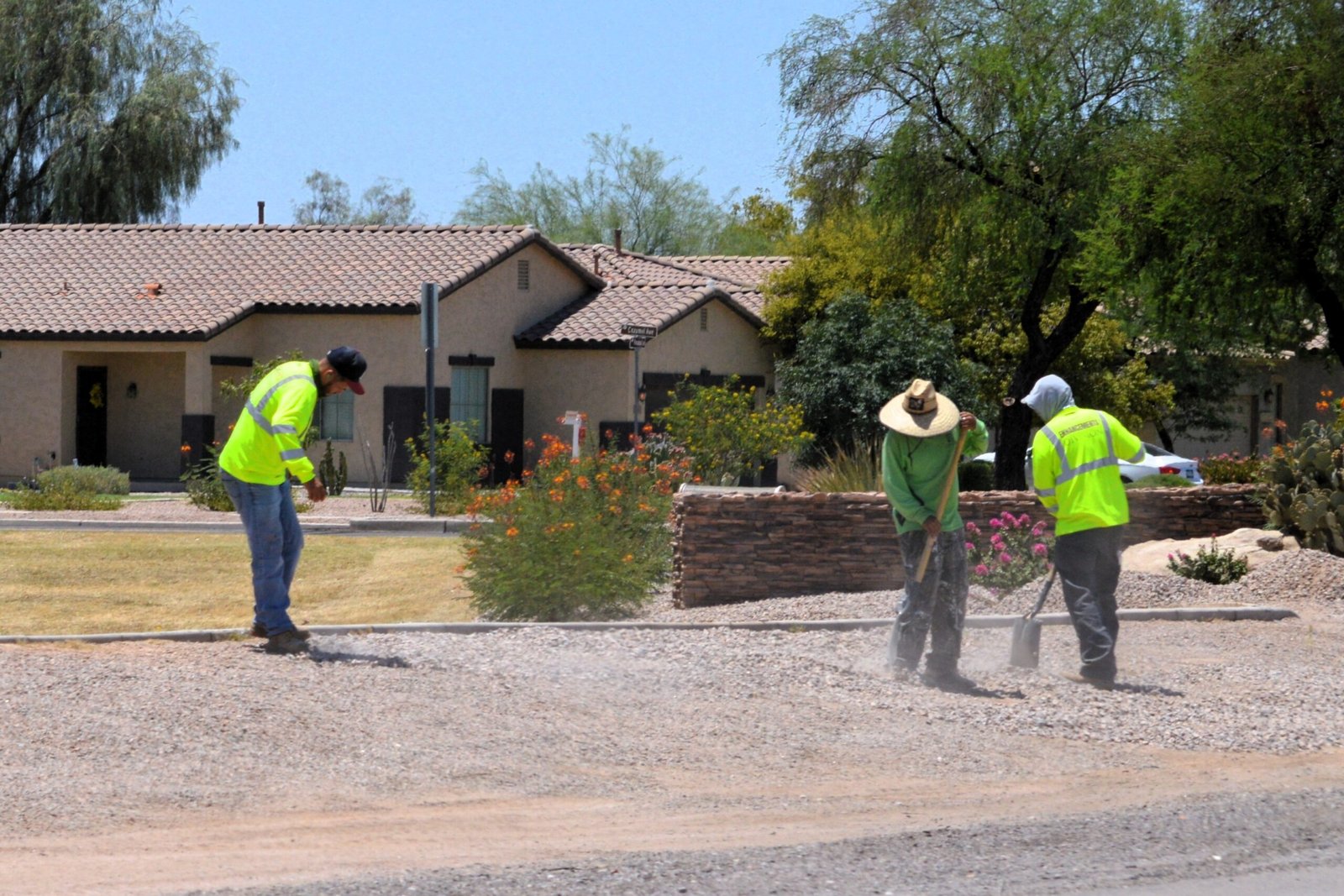Construction,Workers,Landscaping,In,Residential,Neighborhood,On,Hot,Sunny,Day